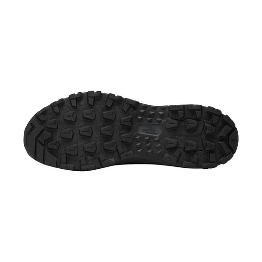 Black hiking shoe outsole with deep lug tread and The North Face logo