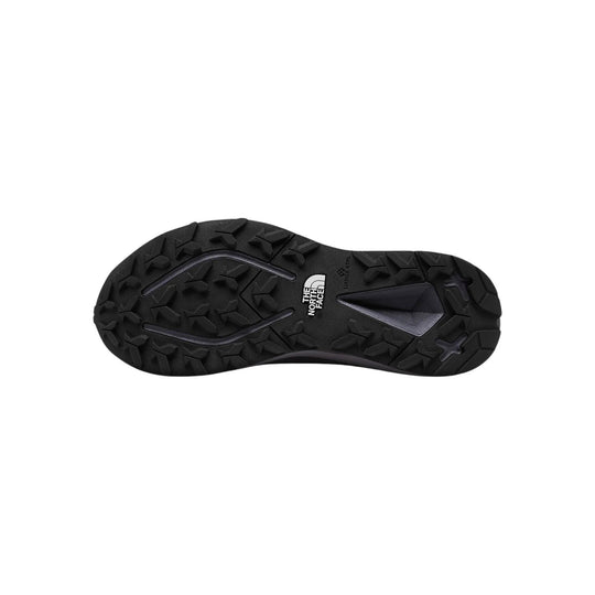 Black hiking shoe outsole with deep lugs and The North Face logo