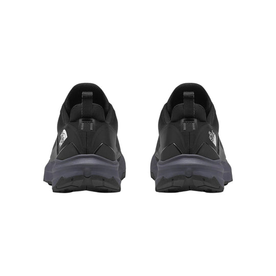 Black trail running shoes shown from the back with gray midsoles and The North Face logos