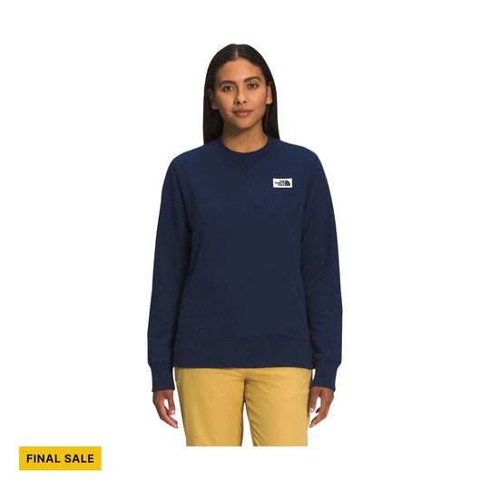 Navy crewneck sweatshirt on a model with a small chest logo and a FINAL SALE badge