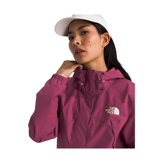 Magenta hooded rain jacket with drawstrings and a white logo on the chest, worn with a white cap