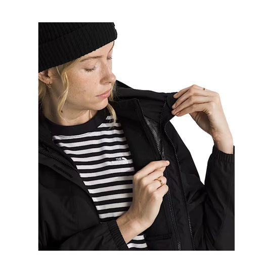 Black hooded jacket over a black-and-white striped shirt, shown being zipped up