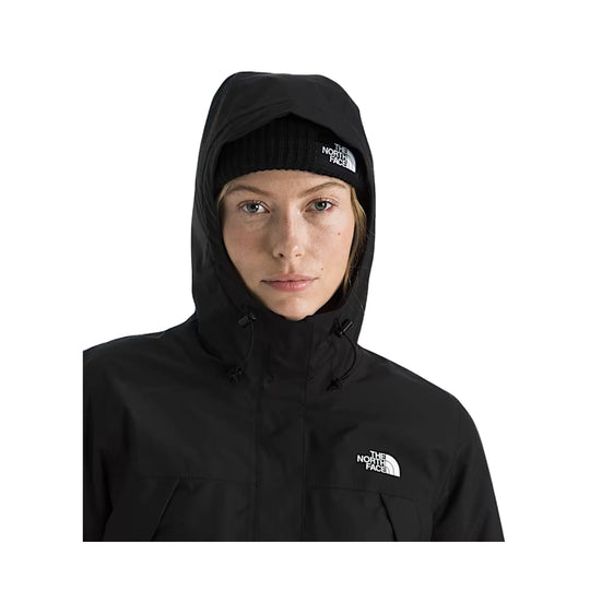 Black hooded jacket on model with front logo and matching beanie.