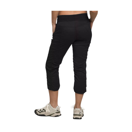 Black cropped hiking pants shown from the back with tapered legs and side pockets