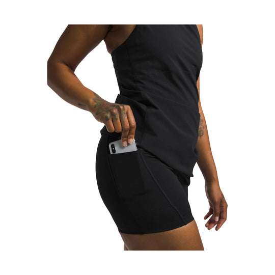 Black sleeveless athletic dress with side pocket holding a phone, shown in side view