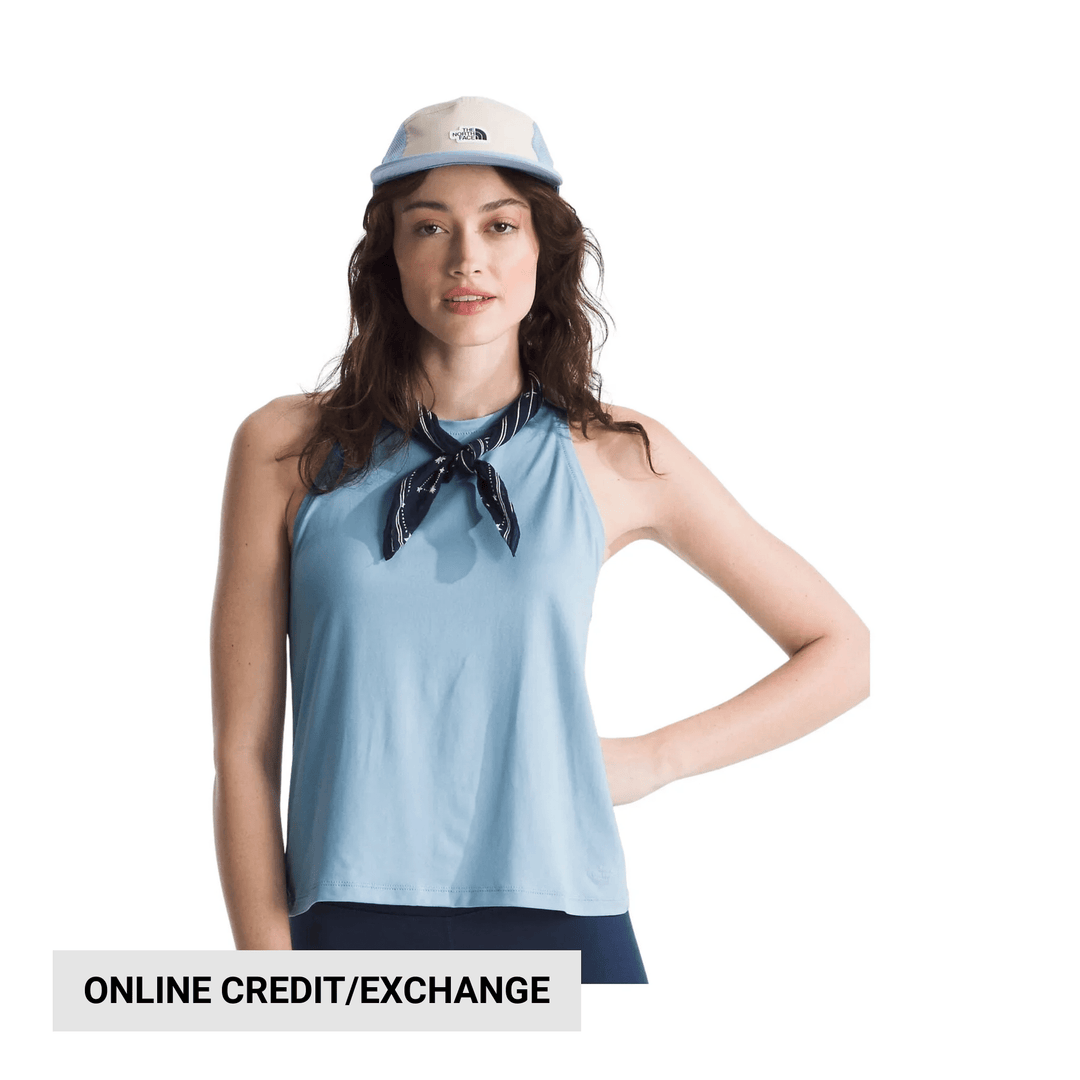 Light blue sleeveless tank top worn with a dark neck scarf and a light blue-and-white cap, with "ONLINE CREDIT/EXCHANGE" text below.