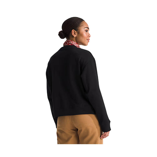Black long-sleeve fleece crew worn with tan pants, shown from the back