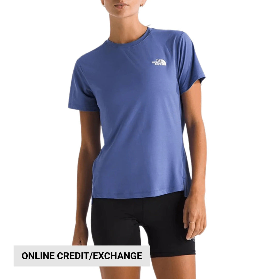 Blue short-sleeve athletic tee with small chest logo and boxy hem, shown on a model