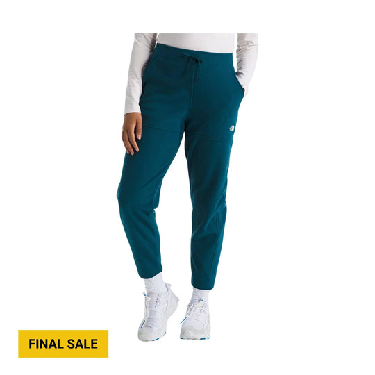 Teal fleece pants with a drawstring waist, side pockets, and tapered legs on a model; FINAL SALE text shown