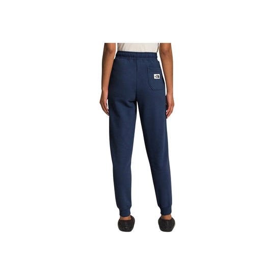 Navy jogger pants with elastic waistband, ankle cuffs, and a small logo patch on the back pocket