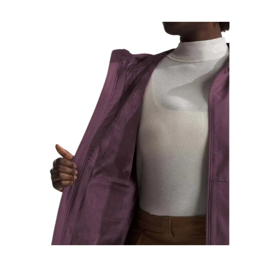 Purple hooded jacket worn open over a white ribbed turtleneck.