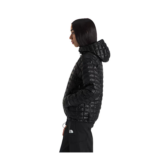 Black quilted hooded puffer jacket shown in side view