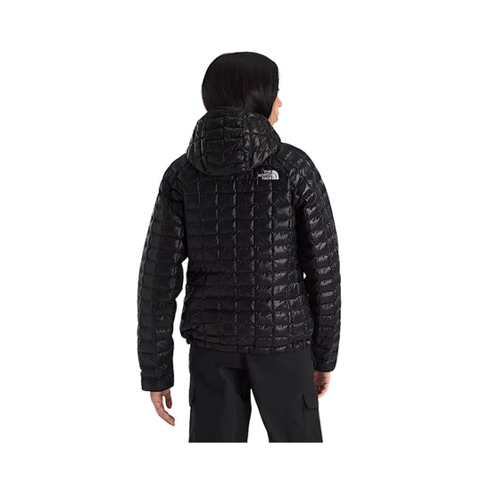 Black quilted hooded puffer jacket shown from the back