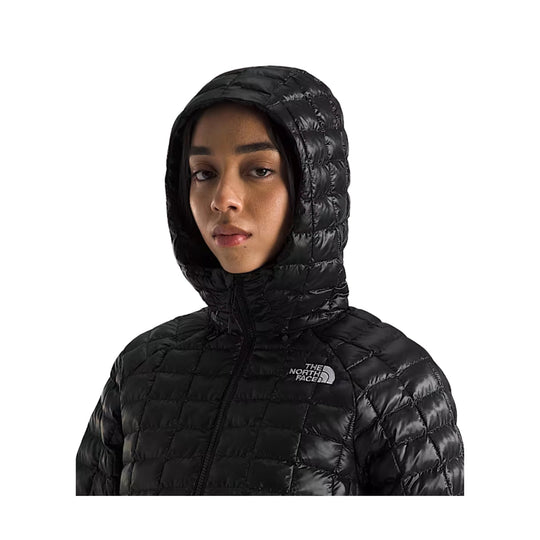 Black quilted hooded puffer jacket with front zip and chest logo