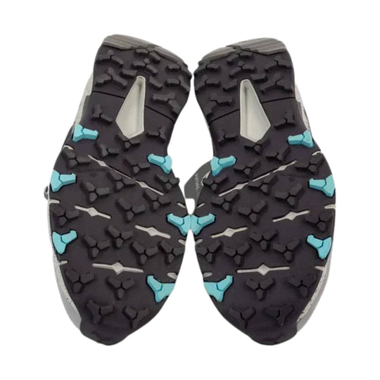 Black hiking boot outsole with blue and gray traction lugs
