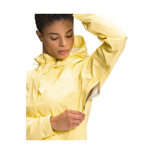 Yellow hooded rain jacket with a front zipper and long sleeves, shown on a model
