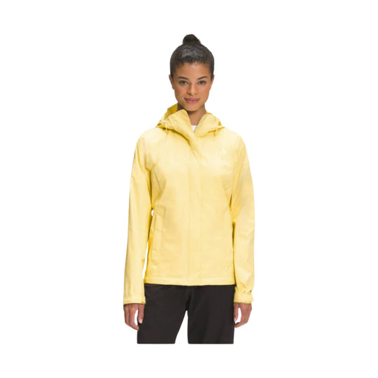 Yellow hooded rain jacket with long sleeves and half-zip front, shown with black pants.