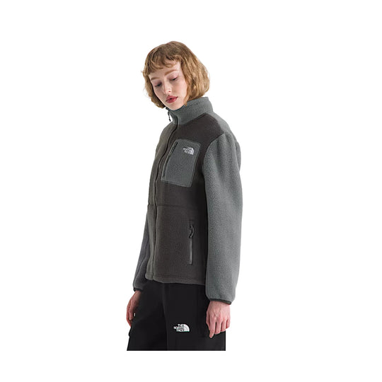 Gray fleece zip-up jacket with high collar, chest pocket, and zippered hand pocket, worn with black pants