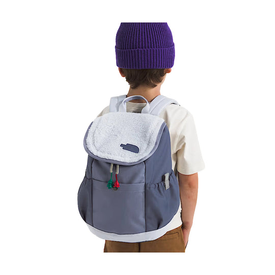 Small gray backpack with a white sherpa flap, back view on a child