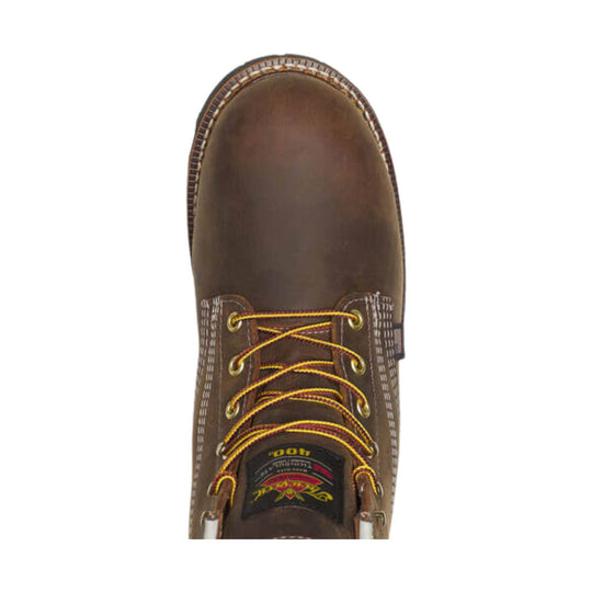 Brown lace-up work boot with yellow laces and a rounded toe, top-down view
