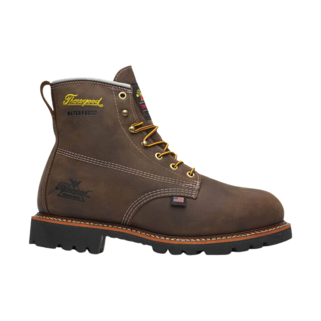 Brown lace-up work boot with yellow laces, thick black lug sole, and stitched welt