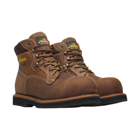 Brown leather lace-up work boots with black soles and visible Thorogood logos