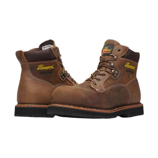 Brown leather lace-up work boots with black soles and visible Thorogood branding
