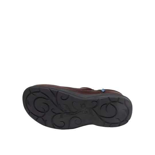Brown slip-on work shoe shown from the sole, with a black swirled tread and small blue tag near the upper edge.