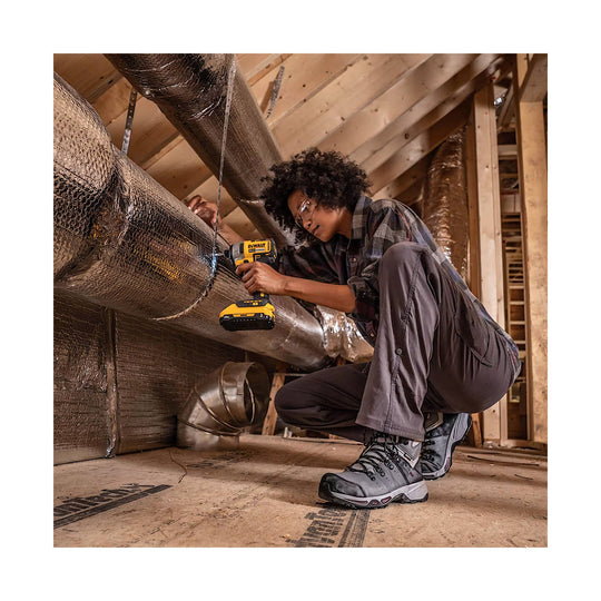 female wearing grey/purple work boots up in an attic