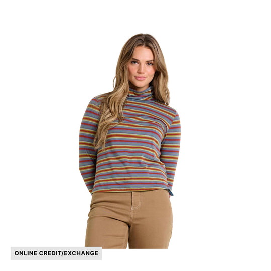 Woman wearing a striped long-sleeve turtleneck top with tan pants; visible text reads ONLINE CREDIT/EXCHANGE