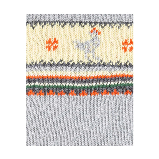 Close-up of a knit cardigan with gray, cream, orange, and green striped pattern