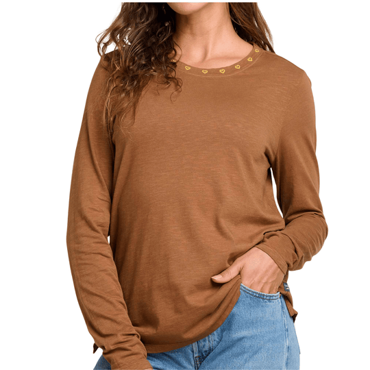 Brown long-sleeve crewneck top with small heart embroidery around the neckline, worn with jeans.