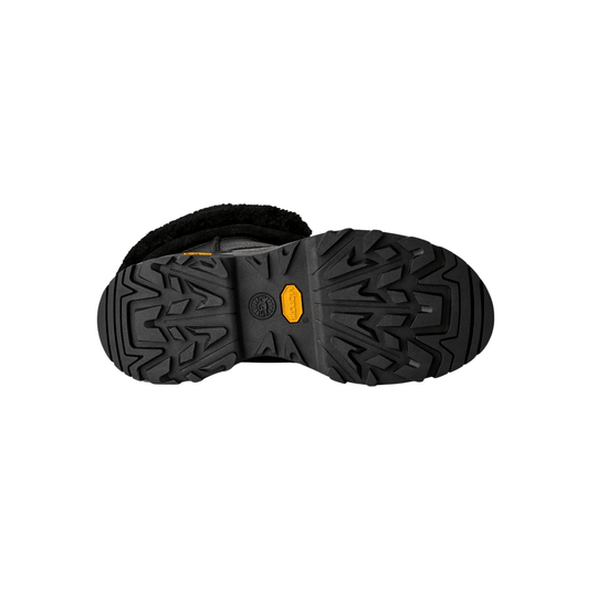 Black boot sole with deep tread and UGG and Vibram logos