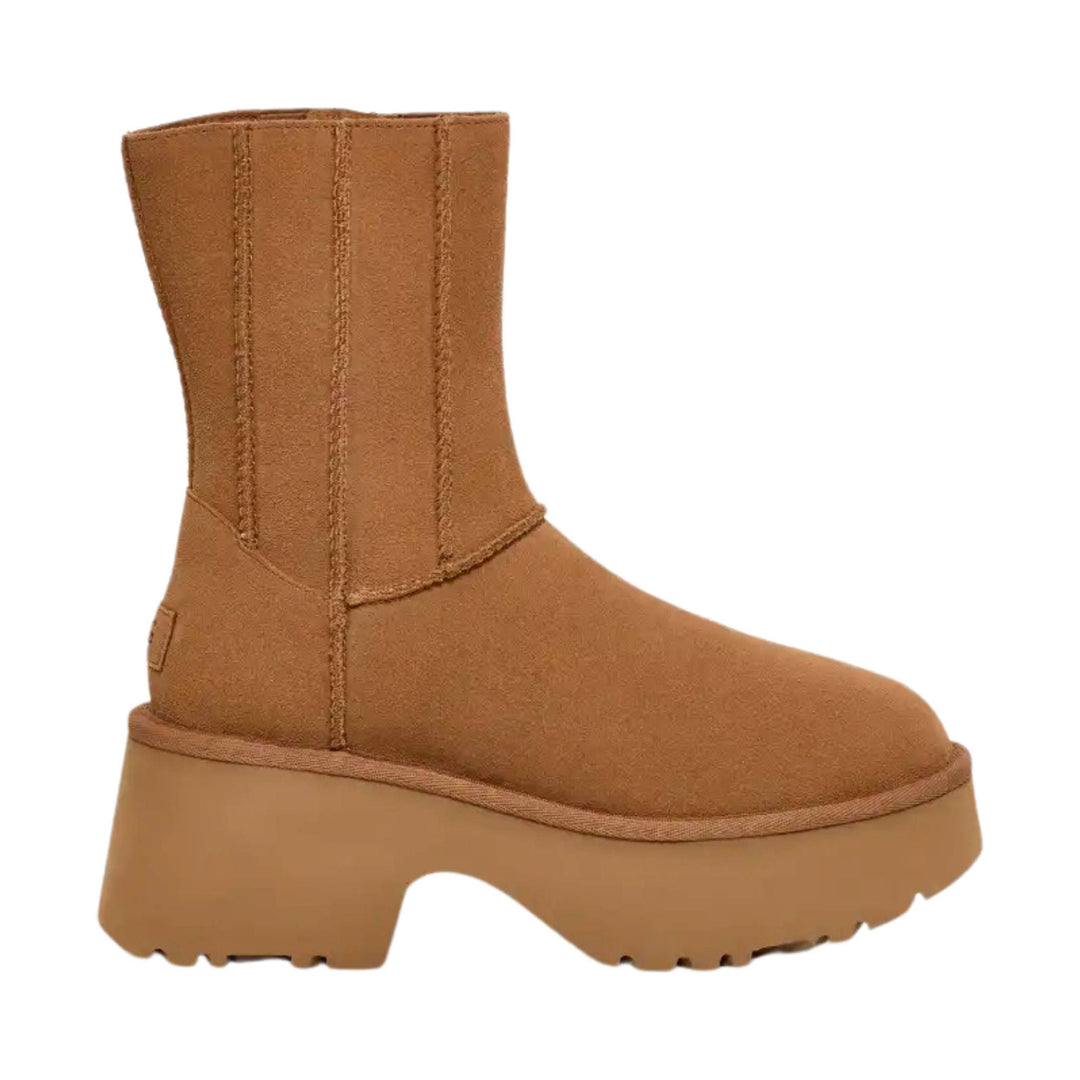 Tan suede ankle boot with a thick platform sole and tall shaft