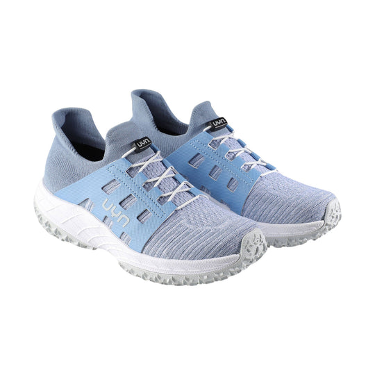 Light blue slip-on athletic shoes with knit uppers, side cutouts, and white soles