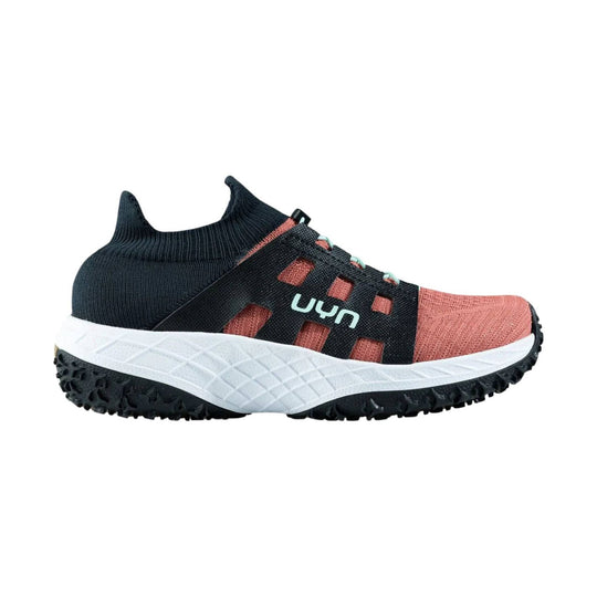 Coral knit trail shoe with black sock-like collar, side straps, and white cushioned sole