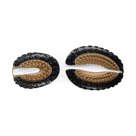 Pair of black and tan shoe soles with oval tread pods and visible UYN branding