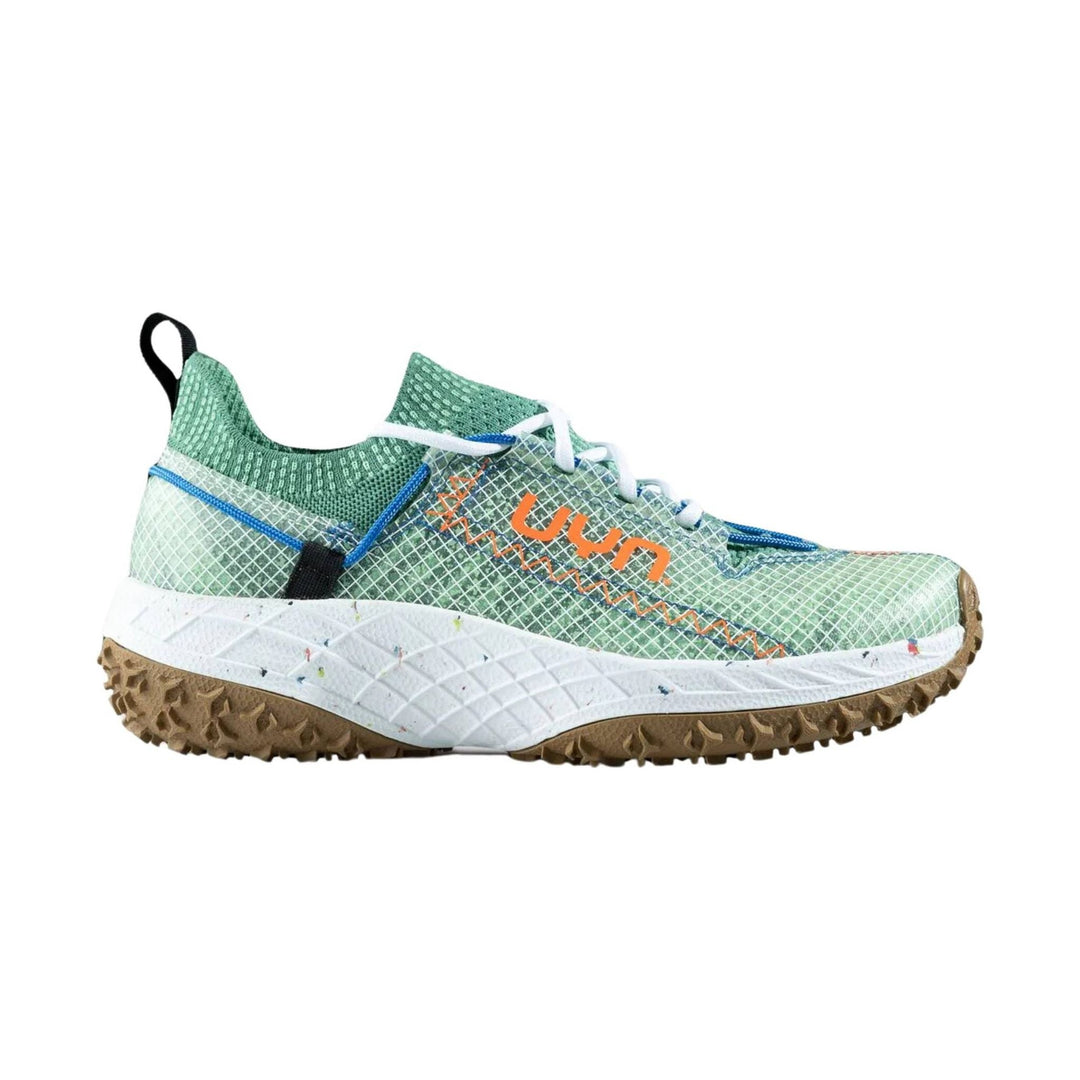 Green trail running shoe with white laces, orange side branding, and a brown lug outsole