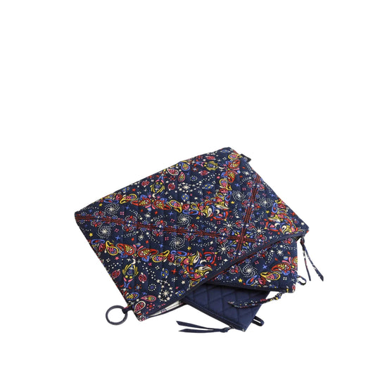 Three navy zip pouch organizers with colorful paisley and star print, stacked on white background