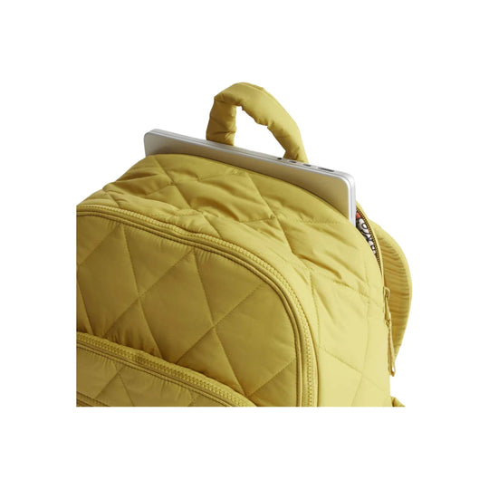 Quilted golden olive backpack with a padded top handle and a laptop partially tucked into the main compartment