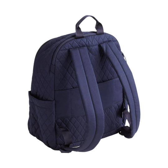 Navy quilted backpack with top handle, front pockets, and padded shoulder straps