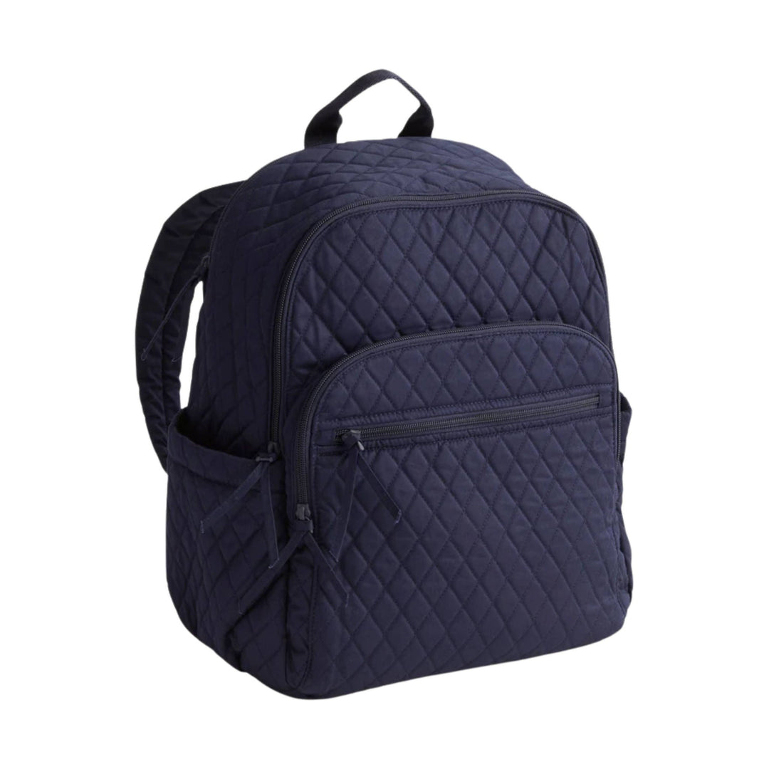 Navy quilted backpack with front zip pocket and top handle