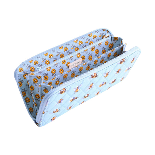 Light blue zip-around wallet with orange floral print and a quilted exterior, shown open