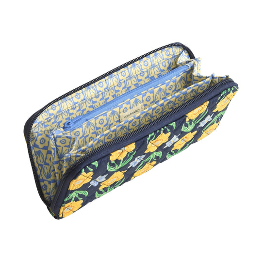 Open zip-around wallet with navy floral exterior and blue-and-yellow patterned interior