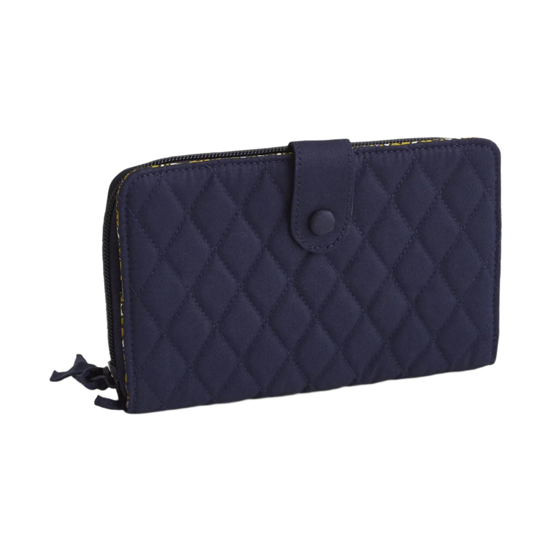 Navy quilted zip-around wallet with a snap tab closure