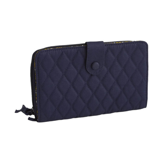 Navy quilted zip-around wallet with a snap tab closure