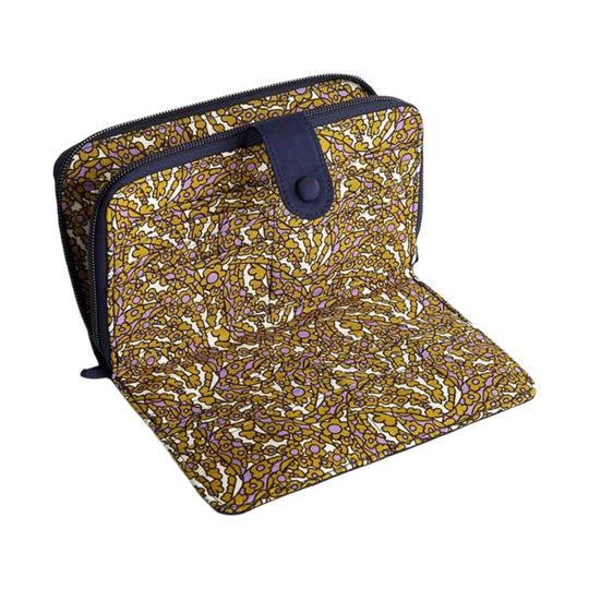 Fold-out wallet in a gold, purple, and white floral pattern with dark trim and a snap tab closure