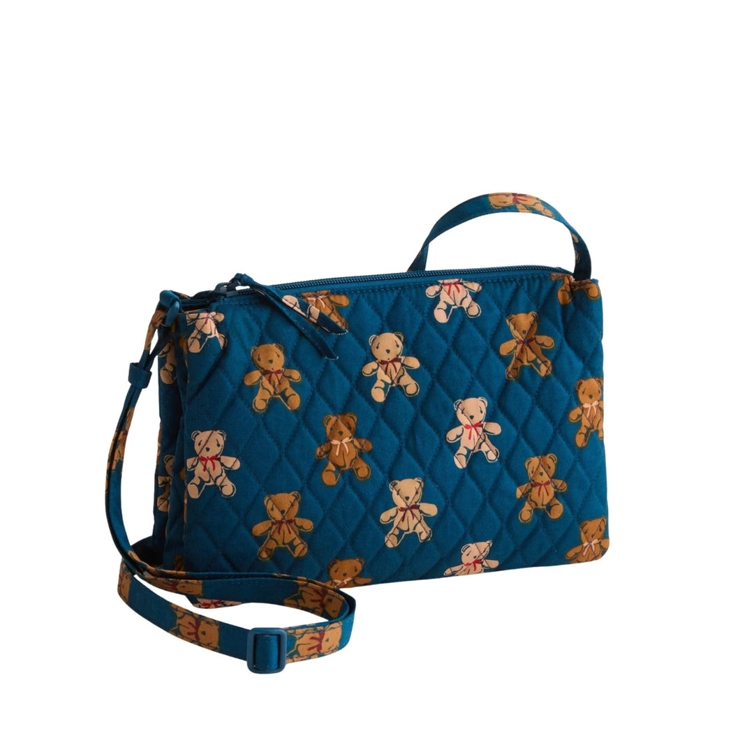 Blue quilted crossbody bag with teddy bear print, top zipper, and adjustable shoulder strap