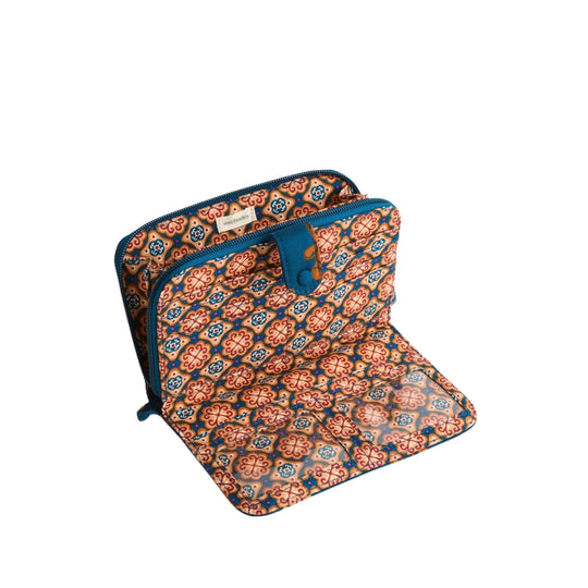 Patterned zippered wallet with a fold-out panel and blue trim, shown open