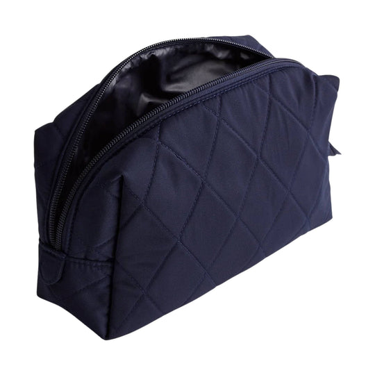 Navy quilted zippered cosmetic bag with black lining and rounded top